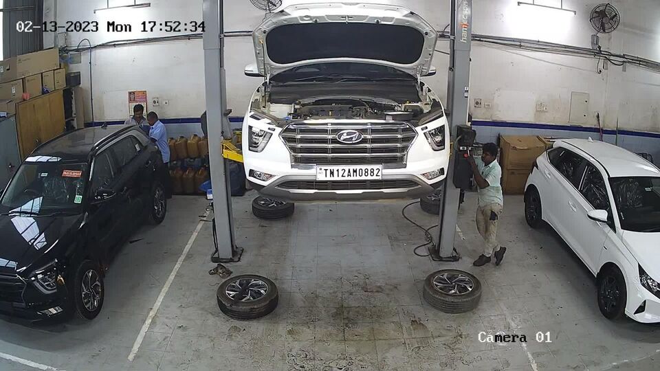 Online view of a auto repair shop bay with a vehicle on the lift